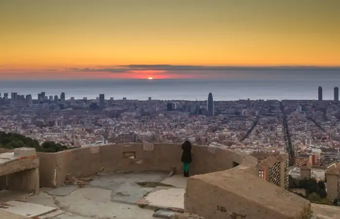 Barcelona'daki Bunkers del Carmel’in üzerinden gün doğumunu izleyen bir kadın